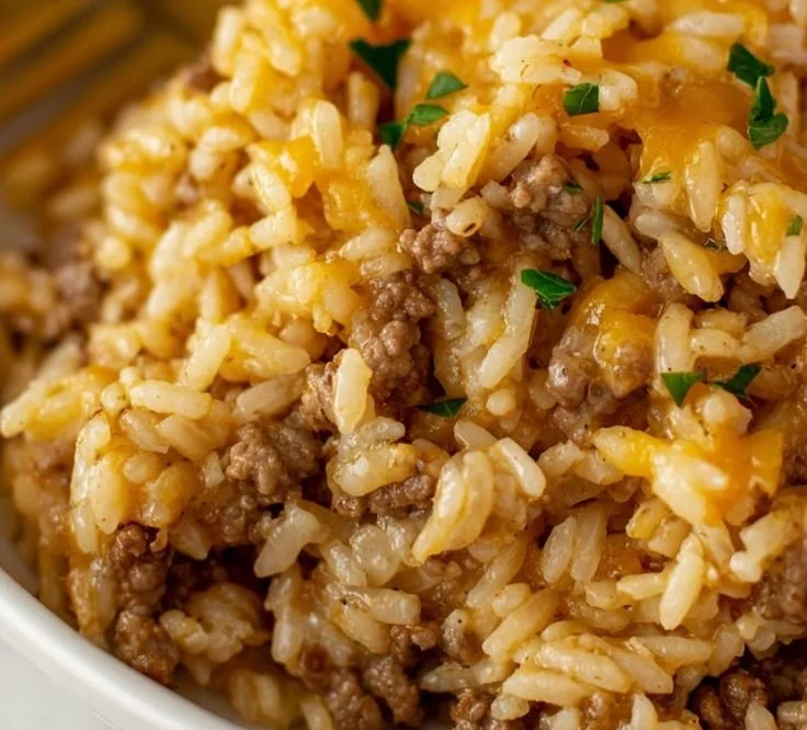 Cheesy ground beef and rice casserole served in a baking dish