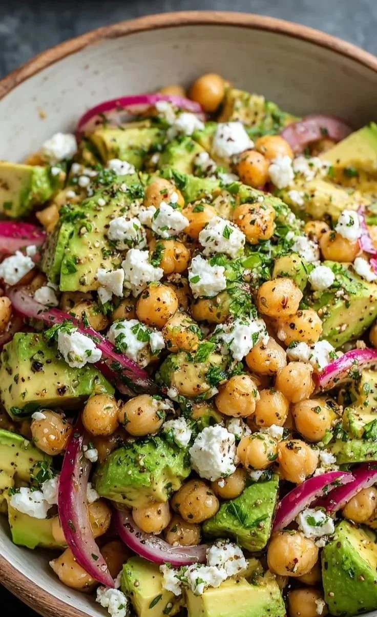 Chickpea avocado feta salad served in a bowl with fresh ingredients