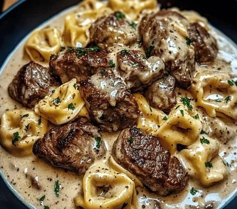 Cracked garlic steak tortellini served in a creamy sauce