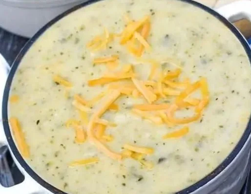 Creamy zucchini soup served in a bowl with fresh herbs on top