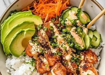 Crispy salmon bowl with fresh vegetables and rice, a healthy family meal