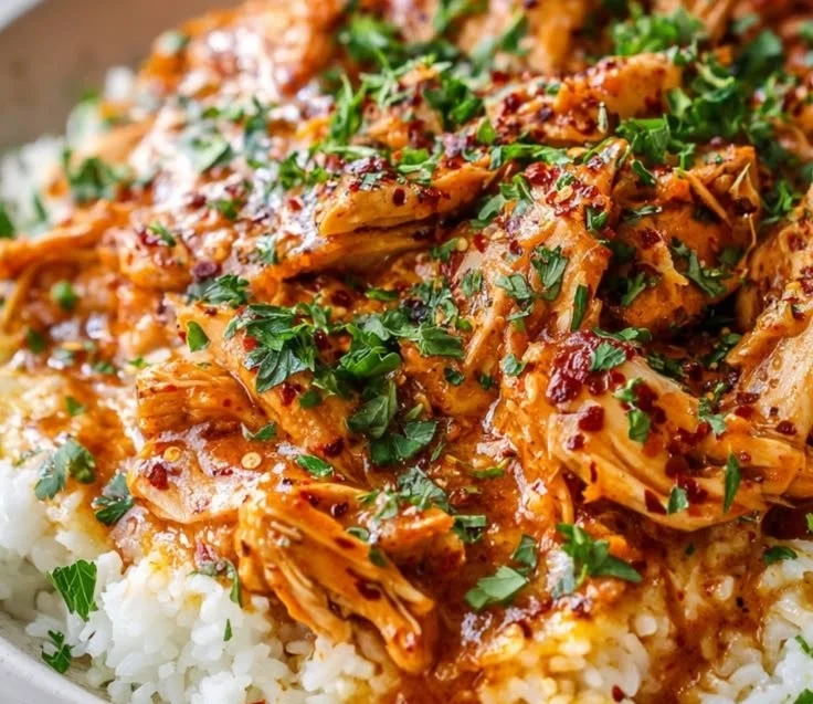 Crockpot Cajun Butter Chicken served in a white bowl with a creamy sauce