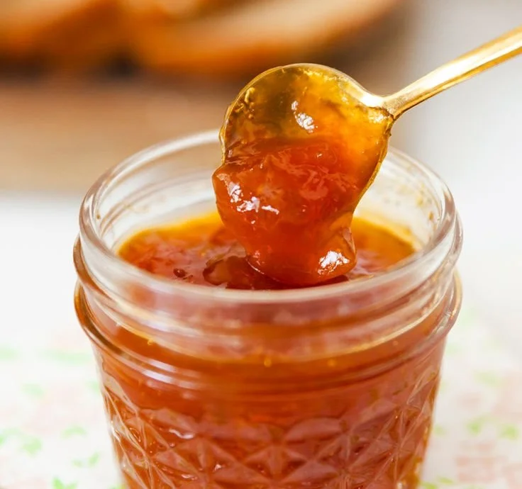 Homemade apricot jam without pectin in a jar with fresh apricots