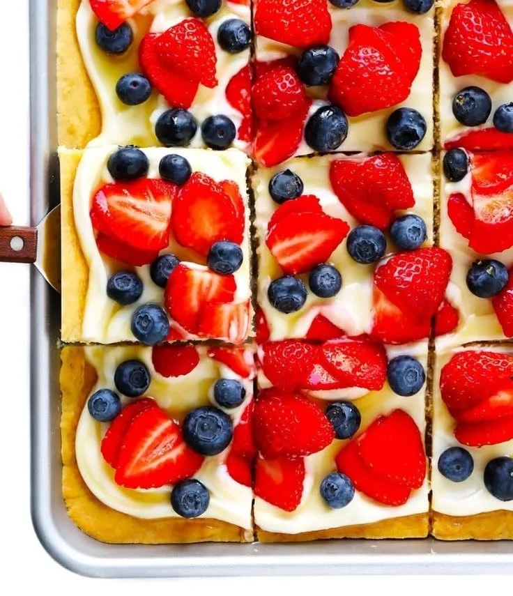 Delicious easy fruit pizza topped with fresh fruits and creamy frosting