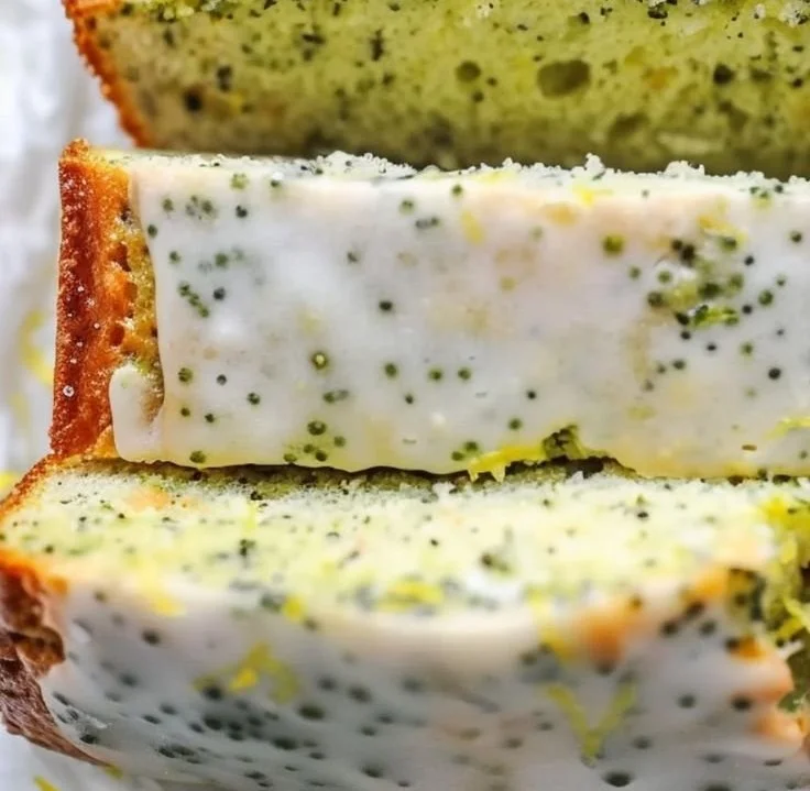Sliced lemon poppy seed zucchini bread on a wooden cutting board