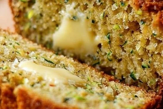 Sliced easy moist zucchini bread on a wooden cutting board