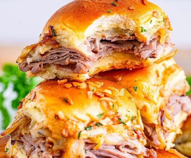 Delicious French Dip Sliders served with au jus for dipping
