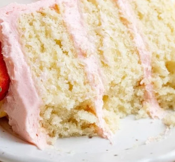 Delicious Fresh Fruit Layer Cake with Strawberry Buttercream decoration.