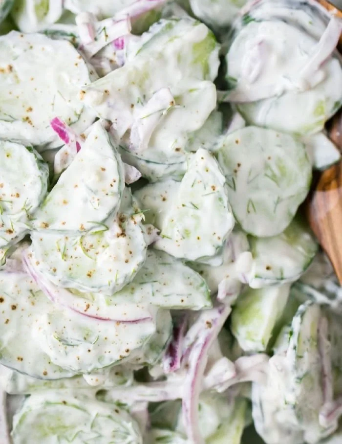 A bowl of German Cucumber Salad with fresh cucumbers and herbs