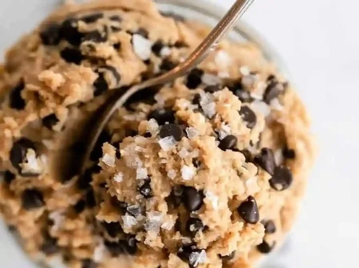 Healthy edible protein cookie dough in a bowl with chocolate chips