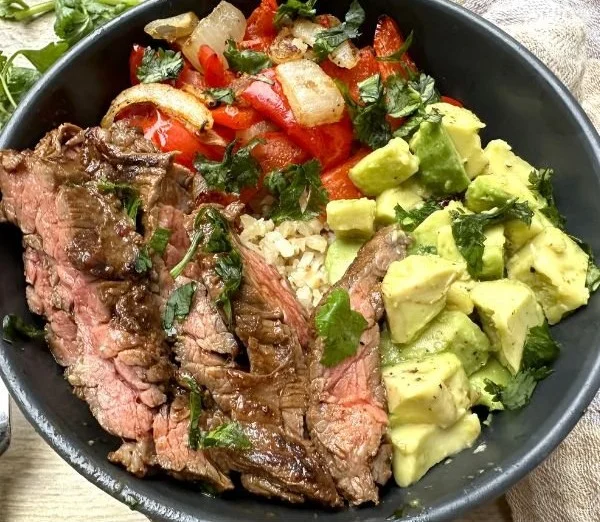 High protein steak fajita bowl with colorful peppers and onions