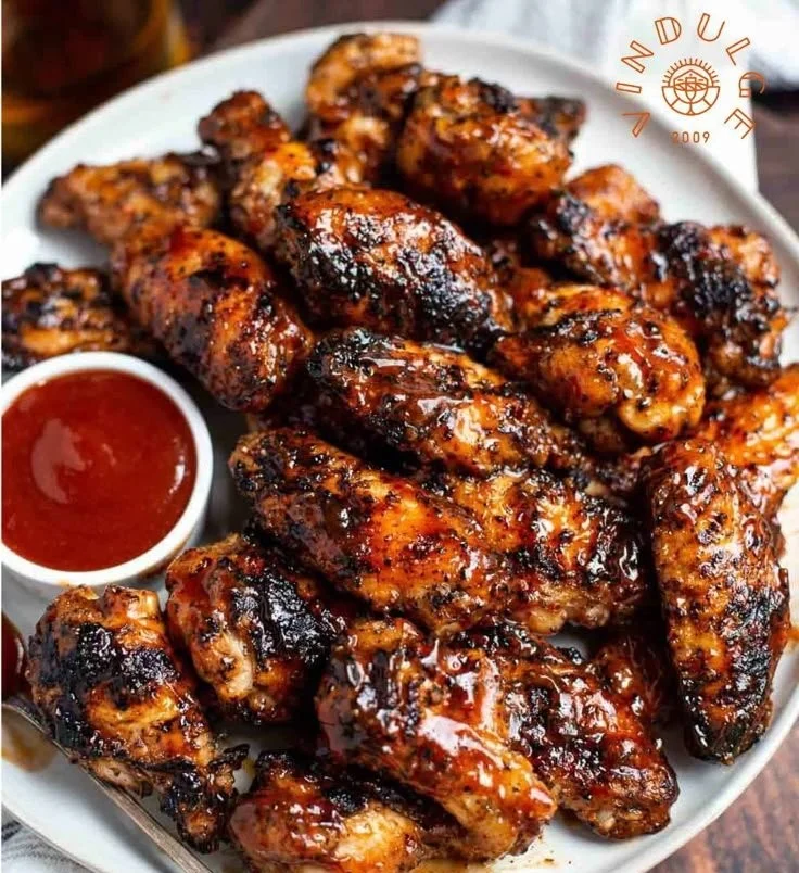 Delicious honey bourbon grilled chicken wings served on a platter.