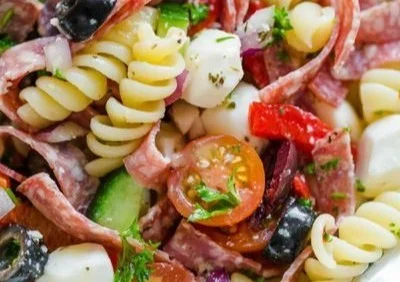 Bowl of colorful Italian Pasta Salad with fresh vegetables and herbs