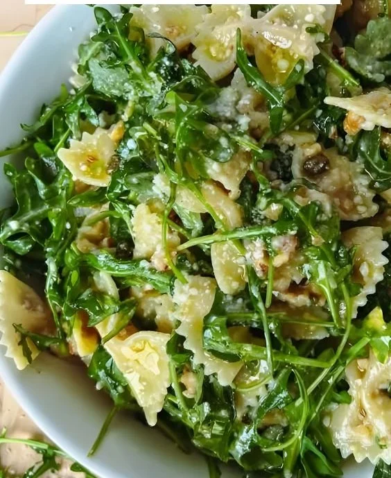 Bowl of Lemon Arugula Pasta Salad with fresh citrus and greens
