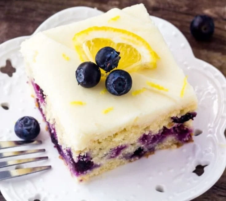Delicious homemade lemon blueberry cake with fresh berries and a citrus glaze