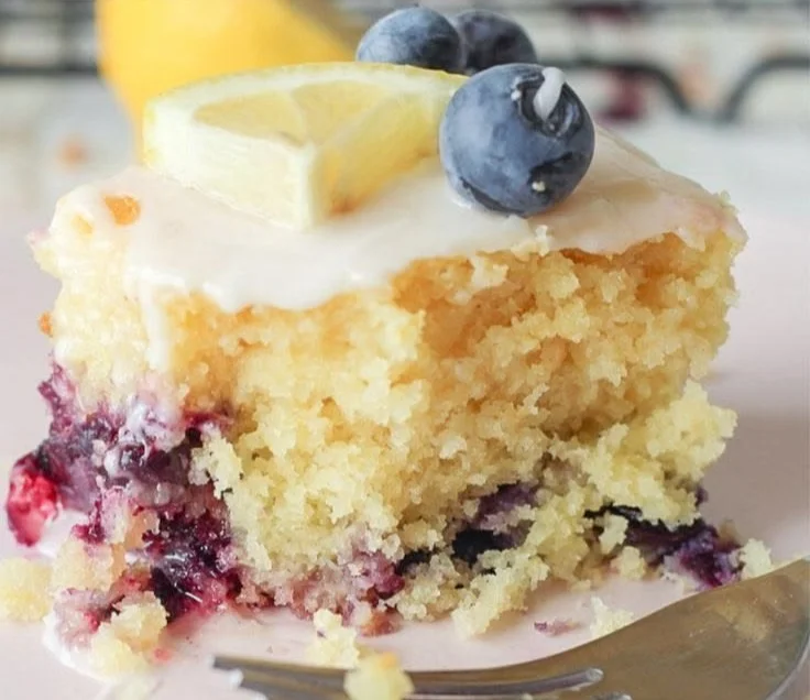 Lemon Blueberry Sheet Cake topped with icing and fresh blueberries