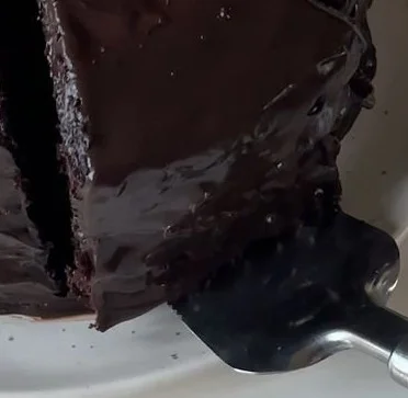 Delicious Matilda Chocolate Cake topped with chocolate frosting and decorations.
