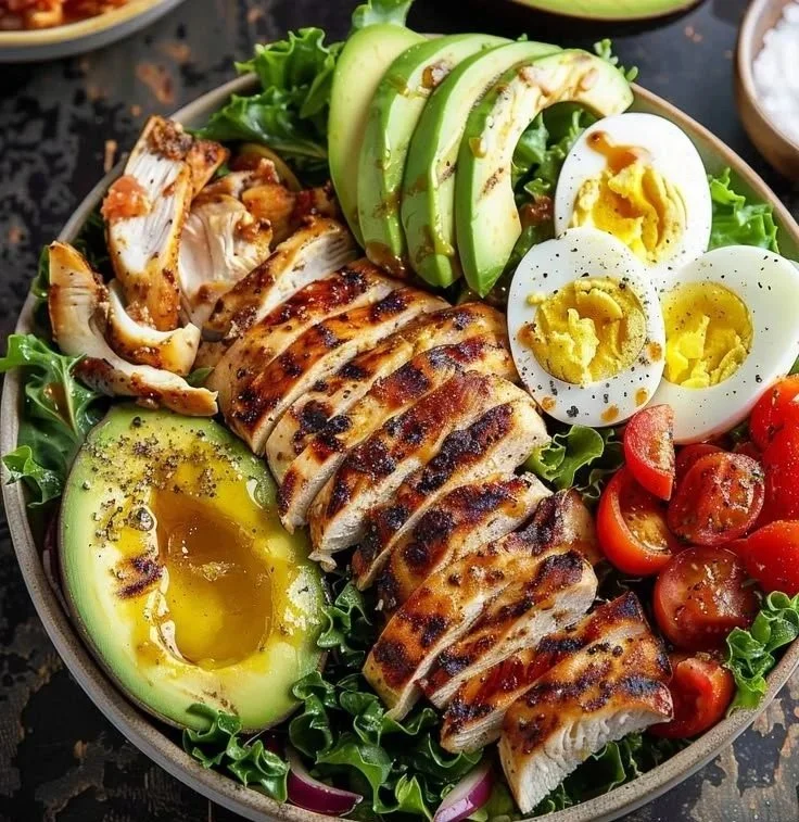 Paleo Grilled Chicken Cobb Salad with Honey Dijon Dressing served in a bowl