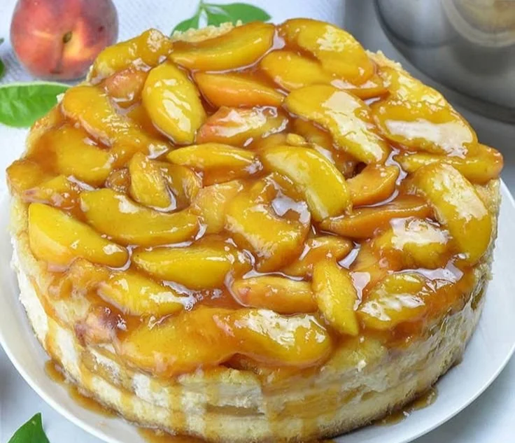 Delicious Peach Cobbler Cheesecake with fresh peach topping and graham cracker crust