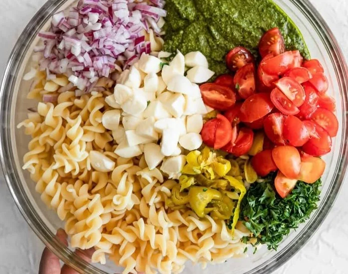 Delicious pesto pasta salad with fresh vegetables and herbs
