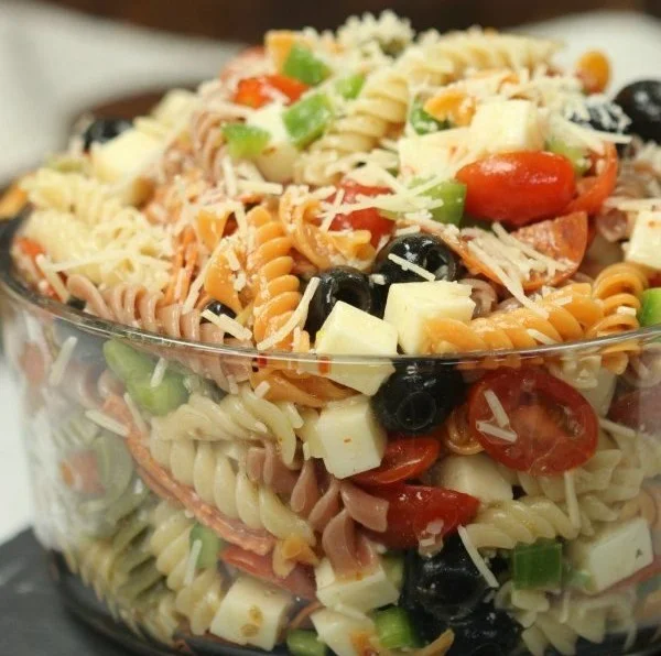 Bowl of quick and easy Italian pasta salad with colorful vegetables and dressing