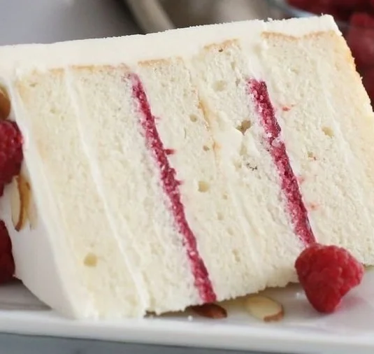Delicious Raspberry Almond Cake topped with fresh raspberries and almonds