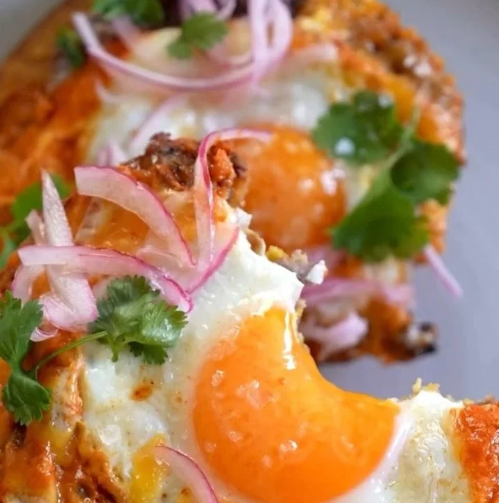 Delicious Red Chile Tostadas topped with eggs, garnished for a vibrant breakfast.