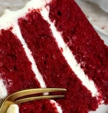Delicious slice of homemade Red Velvet Cake with cream cheese frosting
