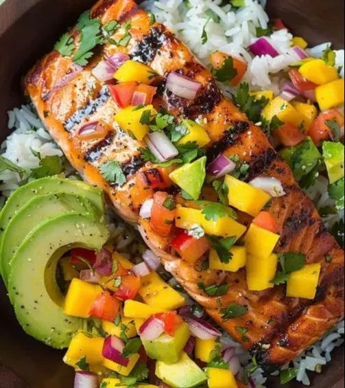Grilled salmon topped with vibrant mango salsa on a plate
