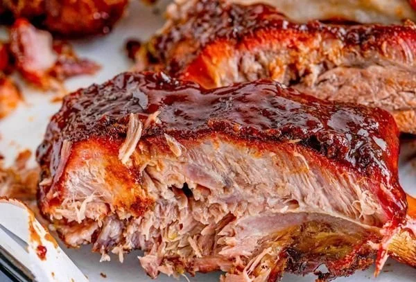 Deliciously smoked ribs ready for serving with BBQ sauce
