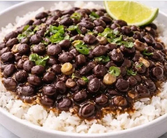 Smoky black beans dish garnished with herbs and spices