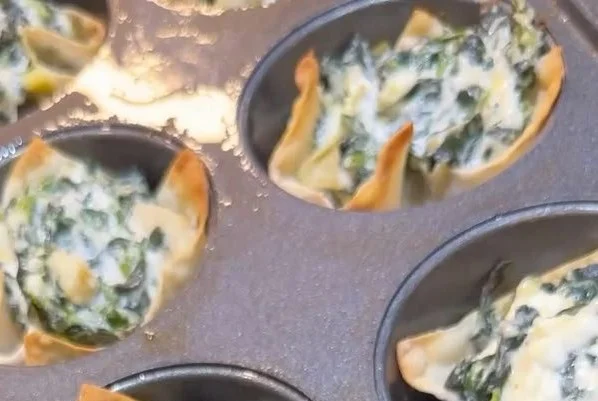 Spinach and artichoke wonton cups served on a platter