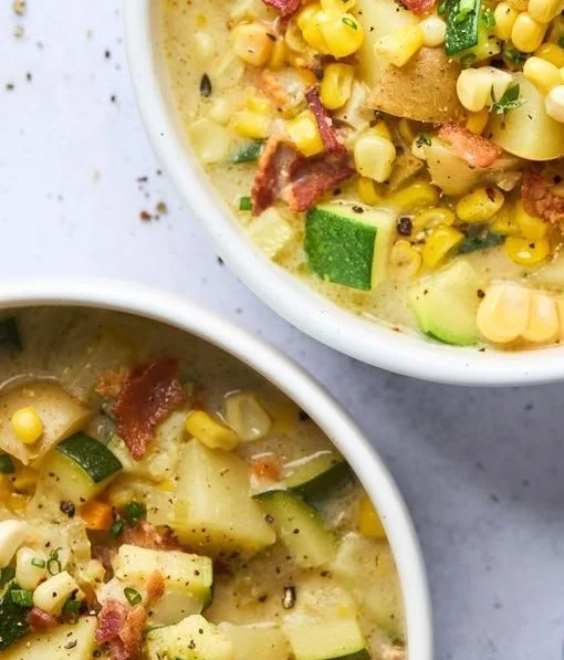 Delicious bowl of Summer Corn Chowder garnished with herbs and fresh corn