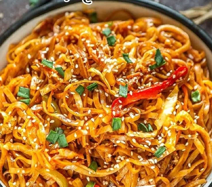 Delicious bowl of sweet and spicy Korean gochujang noodles with ingredients