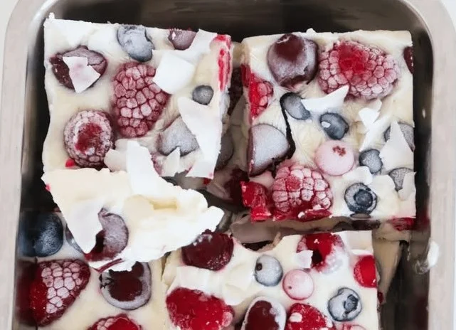 Colorful yogurt bark topped with berries, nuts, and granola, perfect for a healthy snack
