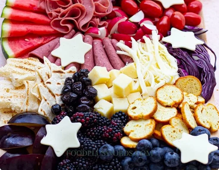 Festive 4th of July charcuterie board with red, white, and blue snacks.