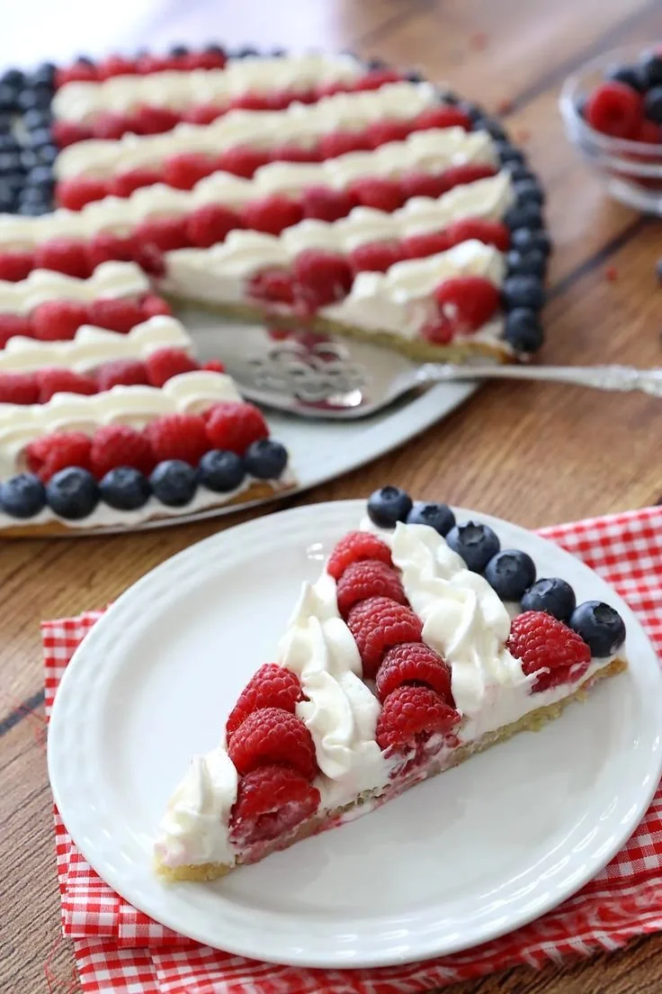 Delicious American Flag Fruit Pizza topped with fresh berries and whipped cream