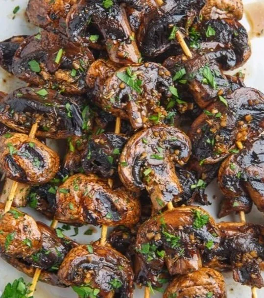 Delicious balsamic garlic grilled mushroom skewers on a BBQ grill