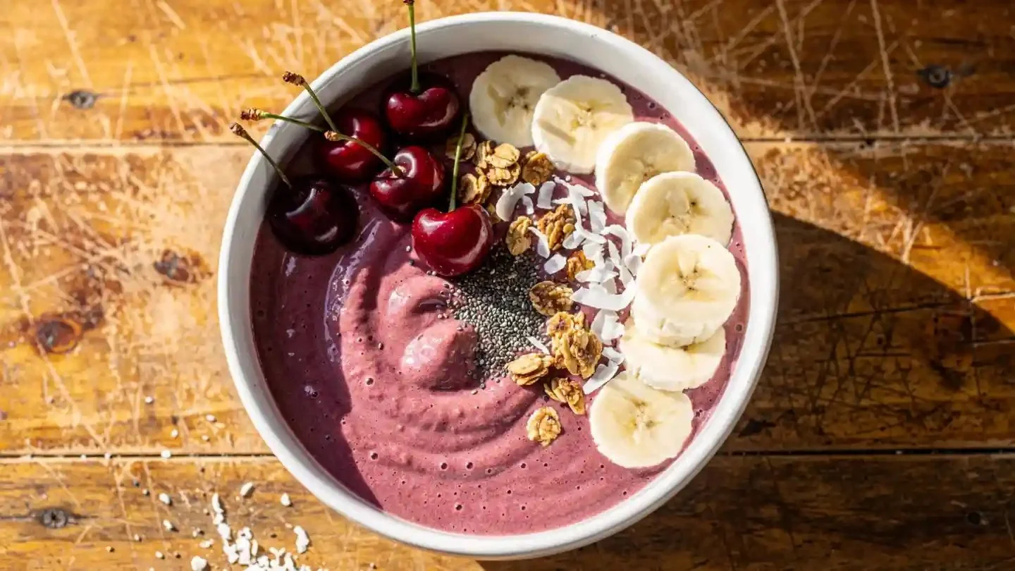 Banana Cherry Smoothie Bowl topped with fresh fruits and nuts