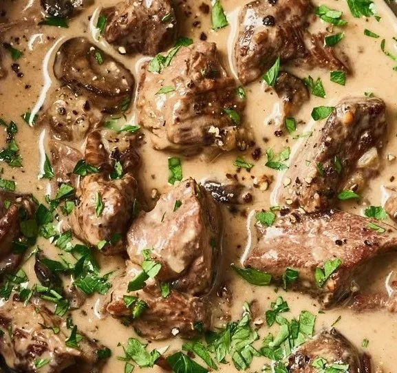 Delicious beef stroganoff served over egg noodles with a creamy sauce.