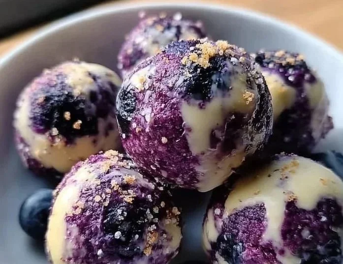 Delicious blueberry cheesecake protein bites on a plate