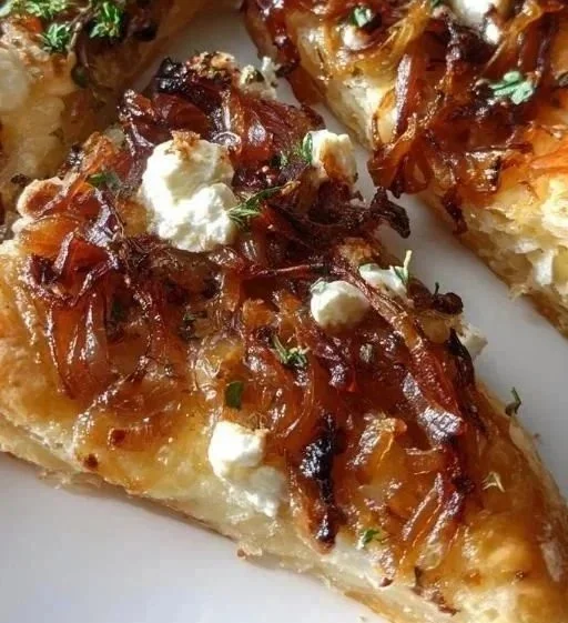 Caramelized onion and goat cheese tarts served on a wooden platter