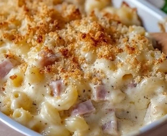 Creamy Chicken Cordon Bleu casserole garnished with herbs in a baking dish