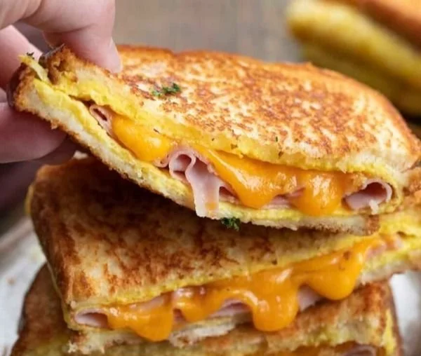 Delicious egg and ham breakfast served on a plate with toast.