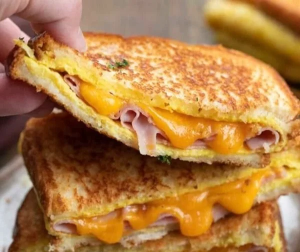 Delicious Egg and Ham Breakfast on a plate with toast and vegetables.