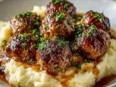 Herbed garlic mashed potatoes served with Salisbury-style beef meatballs.