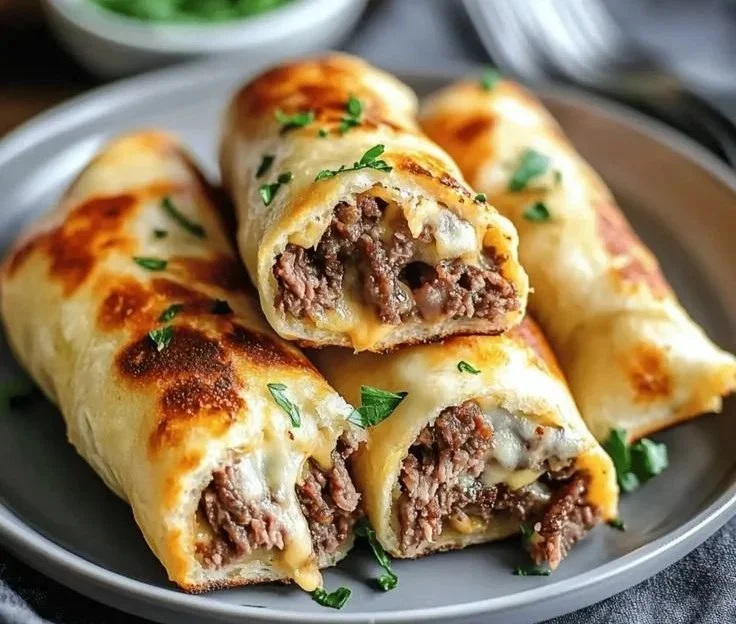 Keto Philly Cheesesteak Rolls recipe with melted cheese and savory filling.