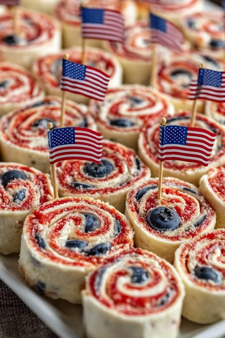 Patriotic Cream Cheese Pinwheels on a platter, perfect for festive gatherings.