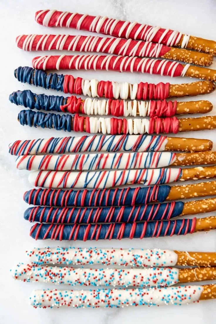 Delicious patriotic pretzel rods decorated with red, white, and blue sprinkles.