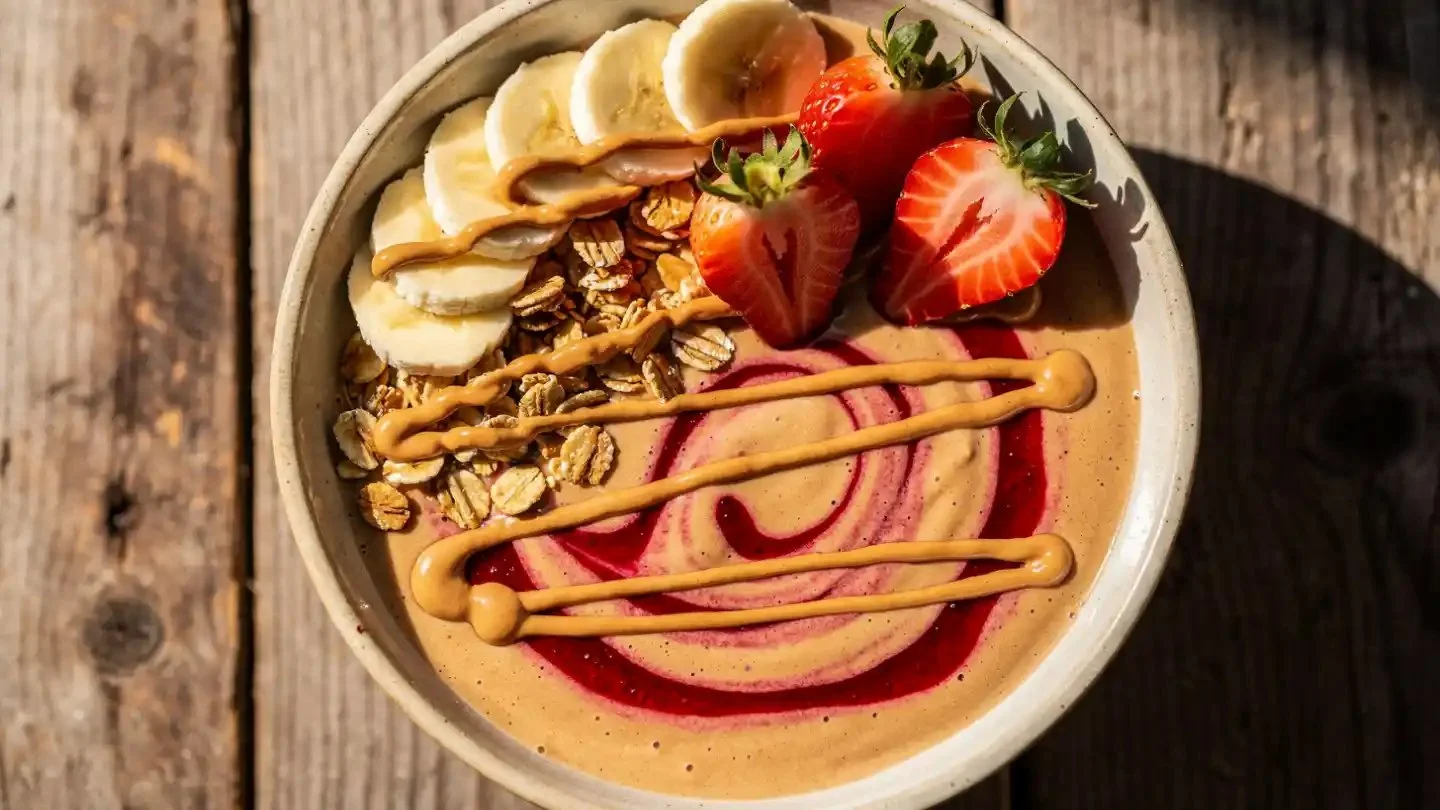 Peanut Butter and Jelly Smoothie Bowl topped with fruits and nuts